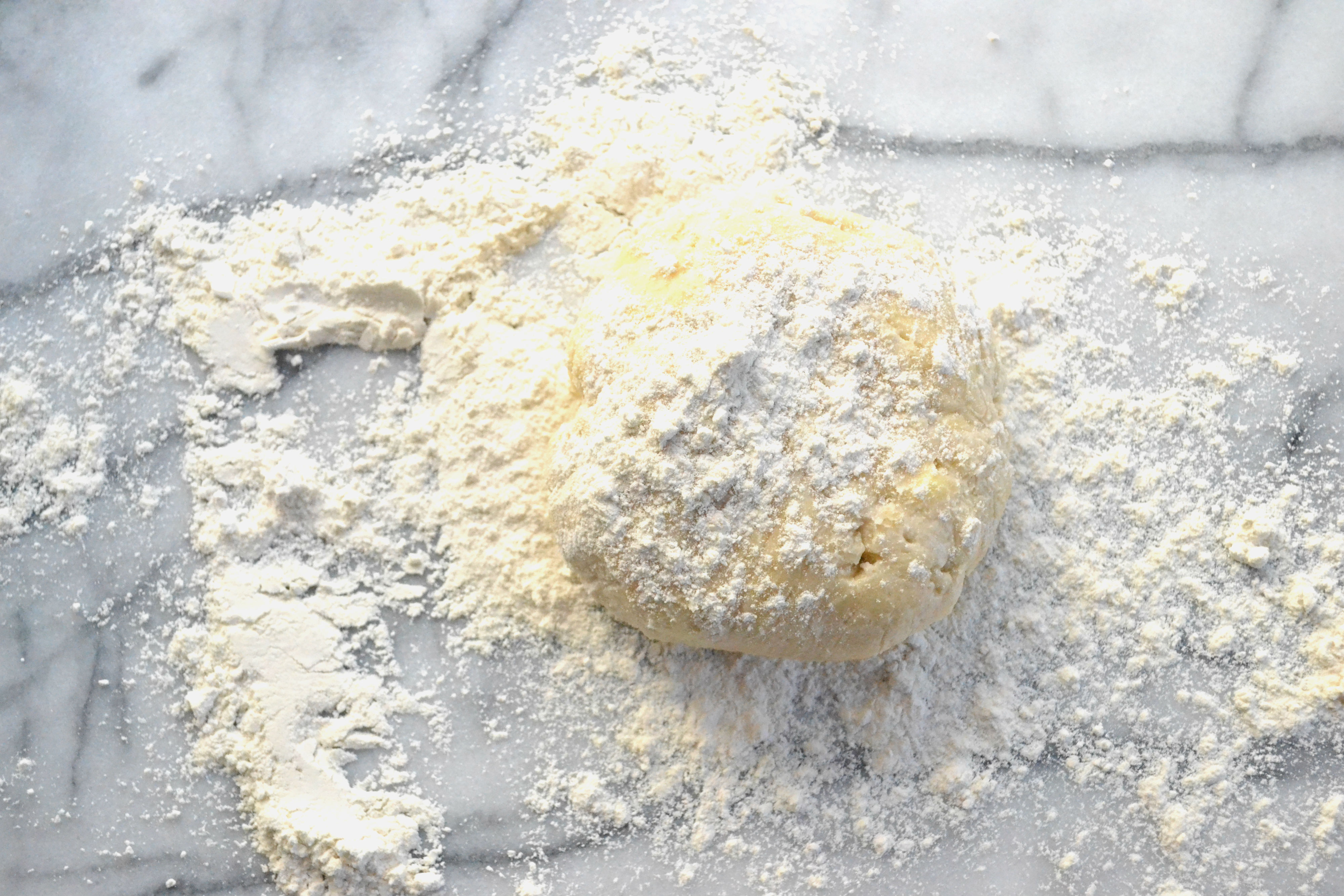 But first put around 1/2 cup of flour on your surface. Then top the dough with an additional 1/4 cup or so of flour. 